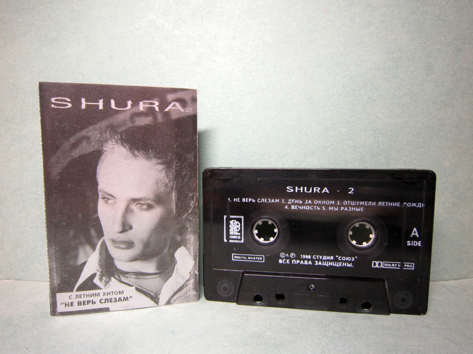 Не верь слезам все вернется текст песни. Shura 2 Шура кассета. Аудиокассеты Шура. Обложка аудиокассеты Шура. Первая кассета Шуры.