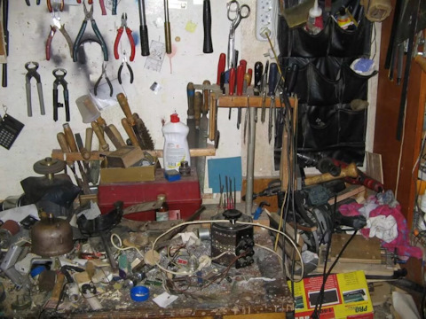 человек ищет нужный инструмент среди хлама